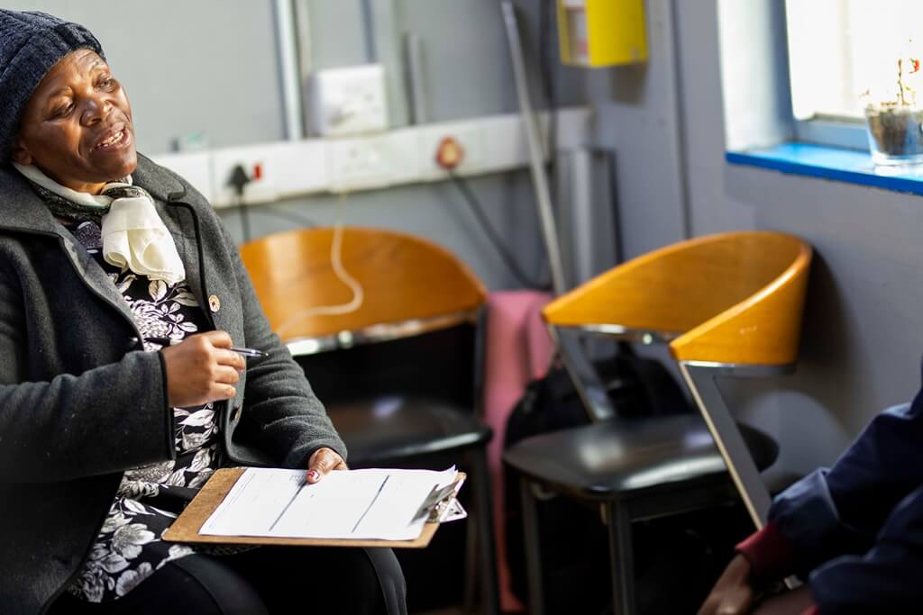 Haven Night Shelter nurse talks with patient