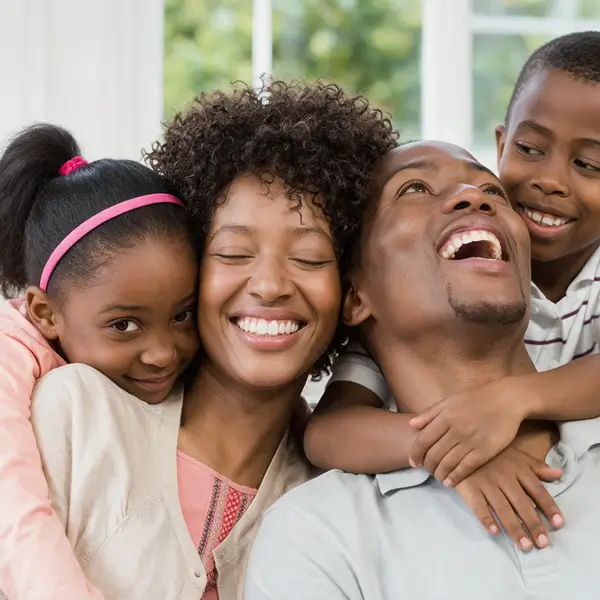 Family laughing together in a lounge
